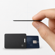 Edge-on view showing the ultra-thin tracking card beside a bank card